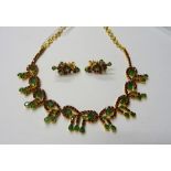 A gold, ruby and emerald necklace, probably Middle Eastern, the front in an entwined design,