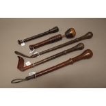 Four leather bound weighted coshes/whips and one further wood and leather cosh with ribbed shaft