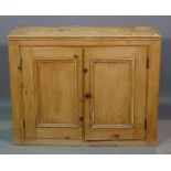 An early 20th century pine side cupboard with panelled doors, 88cm wide x 69cm high.