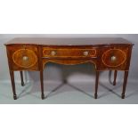 A George III style serpentine mahogany sideboard on tapering spaded supports,