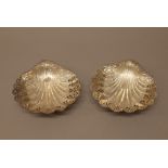 A Victorian pair of silver dishes, each of scallop shell form with pierced and embossed decoration,