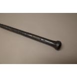 A South Sea Islands ebonised long stick with carved grip and bulbous pommel, 130cm.
