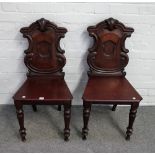 A pair of Victorian mahogany shield back hall chairs, on turned supports, 44cm wide x 89cm high (2).