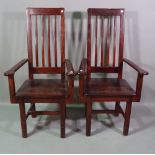 A pair of 20th century hardwood open armchairs, (2).