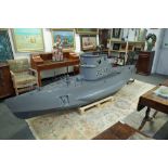 A large model of a submarine, grey painted fibre glass