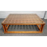 A Japanese rectangular glass top coffee table with soft wood lattice top on turned supports,