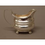 A George III silver milk jug, of helmet shaped form,