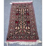 A Beluchistan rug, the field decorated with a stylised flowering plant,