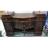 A Victorian style mahogany bowfront sideboard with three drawers over cupboard base,