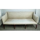 An early 19th century campaign sofa, with bolt-on arms and back on eight stained beech supports,