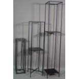 A group of four 20th century black metal jardiniere stands, the tallest, 28cm wide x 160cm high,