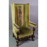 A 17th century Flemish style high square wingback armchair with pierced and carved lower frieze on