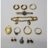 A 9ct gold oval link bracelet, fitted with four charms, a gold,