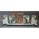An Art Deco onyx, marble and spelter mounted mantel clock garniture,