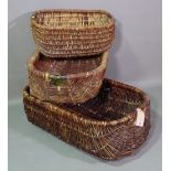 A group of three wicker trugs, the largest 90cm wide x 33cm high.