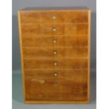 Heals; a 20th century teak and walnut chest of seven long drawers, on plinth base,