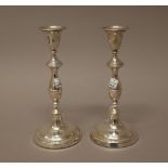 A pair of silver table candlesticks, having knopped stems raised on circular bases, London 1983,