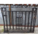A pair of early 20th early black painted wrought iron gates, each 115cm wide x 104cm high, (2).