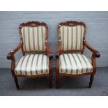 A pair of mid-19th century French mahogany open arm fauteuils on reeded baluster supports,