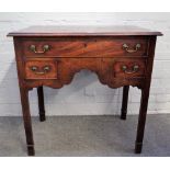 A mid-18th century mahogany lowboy with one long and two short drawers on canted square supports,