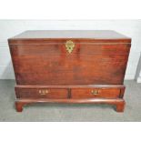 A George II mahogany lift top trunk, in the Irish manner, on a two drawer stand with bracket feet,
