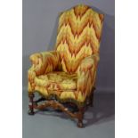 A 19th century mahogany framed highback armchair on turned 'H' frame stretcher.