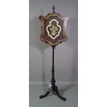 A 19th century Aesthetic movement pole screen with ebonised base,
