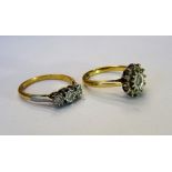 A gold and platinum, diamond set three stone ring,