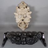 An 18th century and later oak wall mounted stick stand with carved fruit decoration,