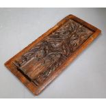 A 17th century carved oak tracery panel, 15cm wide x 32cm high.