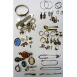 Silver and other jewellery, comprising; two charm bracelets, a bangle, seven brooches, four rings,