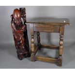 An 18th century and later oak joint stool, 45cm wide x 47cm high and a Japanese hardwood figure,