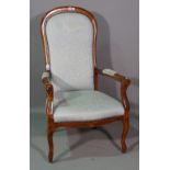 A 20th century mahogany framed spoonback open armchair.