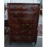 An early 19th century French brass inlaid mahogany tall six drawer chest with caryatid moulds,