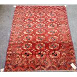A Tekke Turkman rug, the madder field with three columns of seven guls, leaf skirt ends,