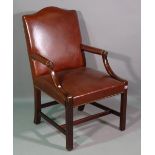 A Gainsborough style mahogany framed open armchair with studded red leather upholstery.