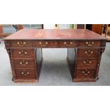 An 18th century style carved mahogany pedestal desk with nine drawers about the knee and opposing