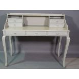A 20th century grey painted desk with three drawers on cabriole supports, 125cm wide x 104cm high.