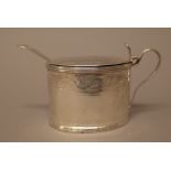 A George III silver mustard pot, of oval form with engraved decoration within reeded rims,