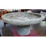 Two 20th century carved stone circular shallow jardinieres/bird baths on turned stands,