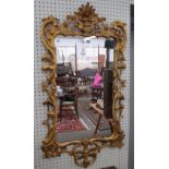 A George III gilt framed mirror with floral chased pierced and carved frame, 63cm wide x 120cm high.