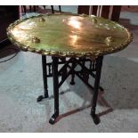 A large brass circular tray top table with associated folding base, (2).