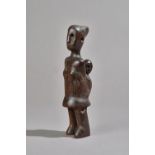 An African tribal hardwood maternity figure, carved with mother carrying a child on her back, 21.