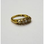 An 18ct gold and diamond set five stone ring, mounted with a row of circular cut diamonds,
