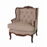 A Louis XV style mahogany framed wingback armchair with cream button back upholstery on cabriole