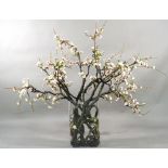 A faux apple blossom arrangement in a glass vase, overall approx. 158cm wide x 143cm high.