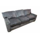 Peter Dudgon; a grey upholstered sofa on block supports,