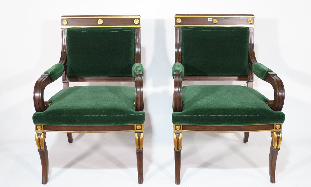 A pair of Regency style mahogany and parcel gilt open armchairs on cabriole supports,