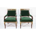 A pair of Regency style mahogany and parcel gilt open armchairs on cabriole supports,