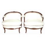 A pair of Louis XVI style mahogany framed tub chairs with white upholstery, on cabriole supports,